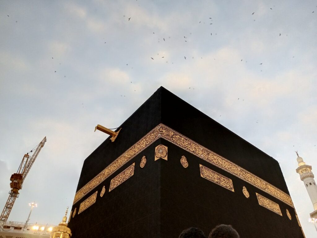 View of the Kaaba at dusk with a clear sky in Mecca, Saudi Arabia.